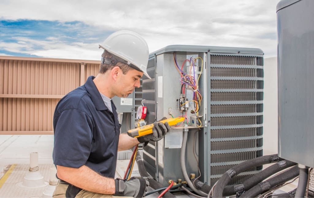 HVAC Technicion Inspecting a Rooftop Heating and Air Conditining Unit