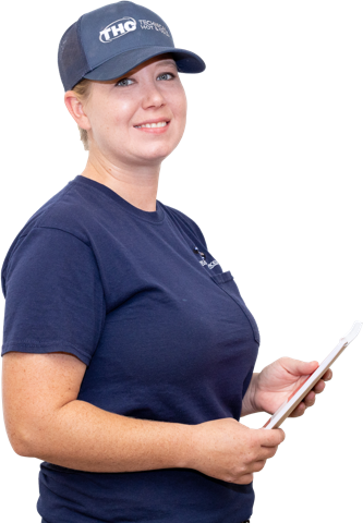 A blonde woman holding a clipboard and wearing a technical hot and cold uniform